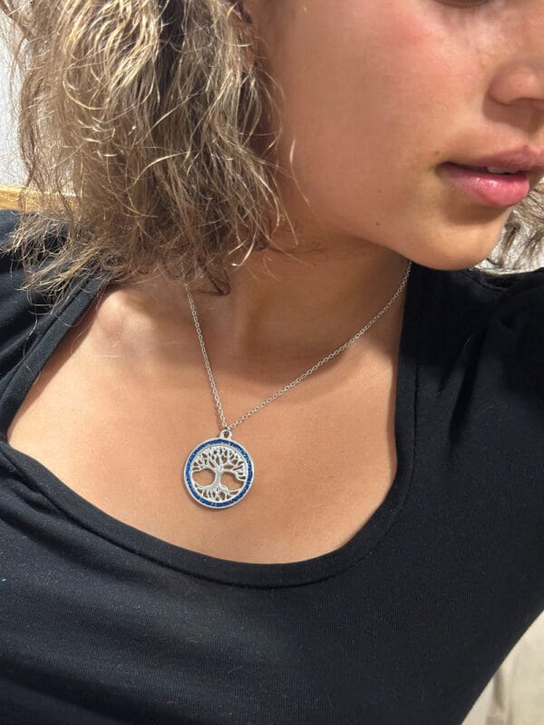 Model wearing tree of life pendant
